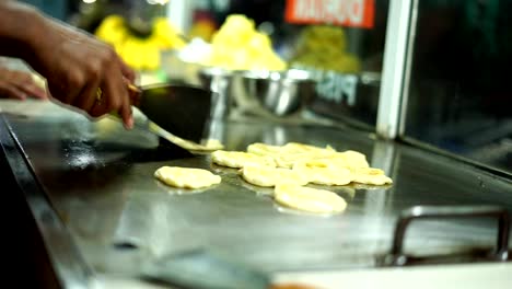 Vendor-Frying-Roti-canai/Indian-flat-bread-at-street-food-market