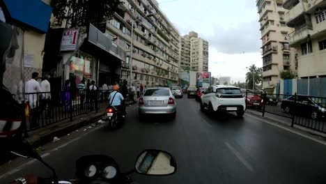 POV-motorcyclist-drives-on-street-with-palms-near-sea-Bombey-timelapse