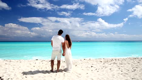 Young-beautiful-newlyweds-on-white-sandy-beach