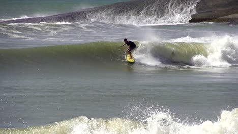 SLOW-MOTION:-Young-surfer-riding-big-wave