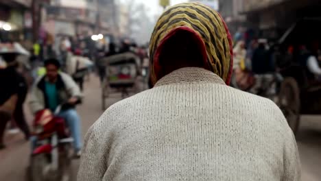 Riding-a-bike-taxi-in-Varanasi,-India.