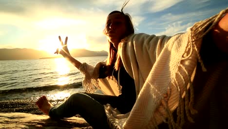 Cheerful-young-woman-by-the-lake-shore,-takes-selfie-portrait