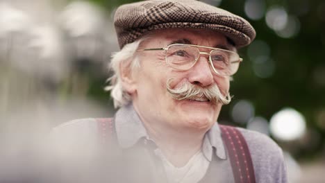 Old-happy-man-sitting-in-nature