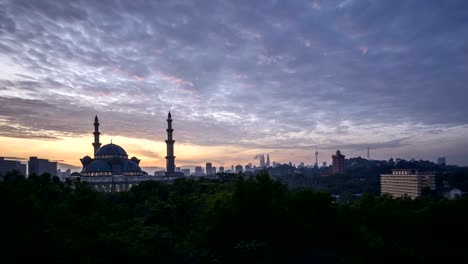 Sunrise-at-Federal-Mosque,-Kuala-Lumpur-with-silhouette-Kuala-Lumpur-city-skyline
