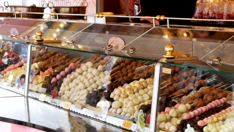 Various-fruit-apples,-bananas-in-the-glaze-on-the-showcase-during-the-world-famous-beer-festival-Oktoberfest,-in-Munich,-Bavaria