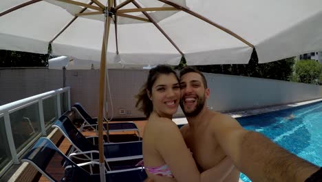 Young-Couple-taking-a-selfie-in-the-Swimming-Pool