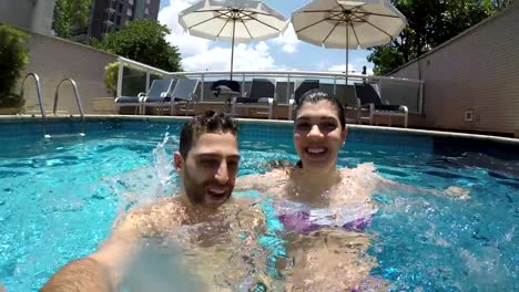 Young-Couple-taking-a-selfie-in-the-Swimming-Pool