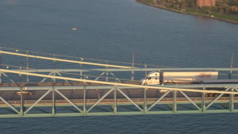 AERIAL:-Semi-trucks-driving-over-the-bridge-into-the-logistics-center-in-Detroit