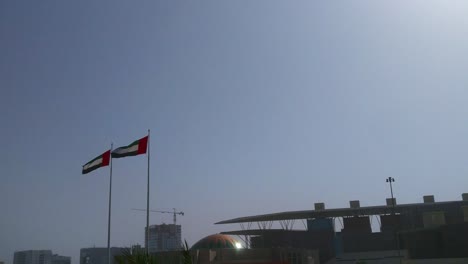 The-United-arab-emirates-flags-waving-in-Abu-Dhabi-city