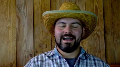 Laughter-of-an-unshaven-man-in-a-straw-hat