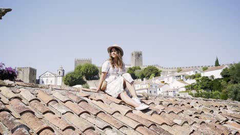 Smiling-woman-sitting-on-roof