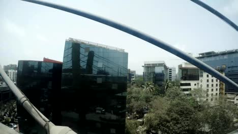 streets-of-Mumbai-with-traffic-reflections-on-glass-buildings-top-view-from-metro-bridge