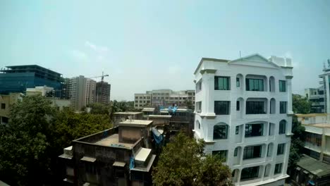 sreets-of-metropolis-glass-buildings-with-reflections-green-trees-top-view-from-metro-bridge