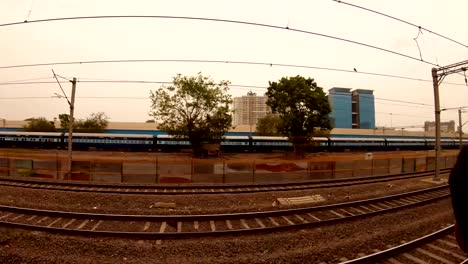 many-raws-of-local-railway-lines-long-train-far-some-many-storied-houses-Mumbai