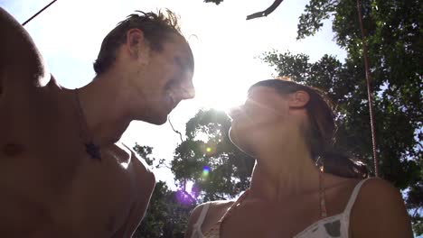 SLOW-MOTION:-Young-man-and-woman-kissing-over-the-sun