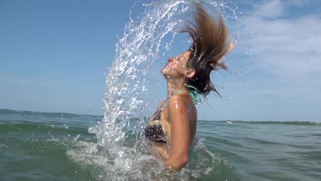 SLOW-MOTION:-Young-woman-splashing-water-with-her-hair