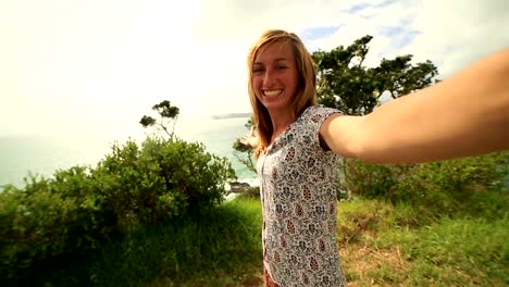 Self-portrait-of-young-woman-on-coastline-hill