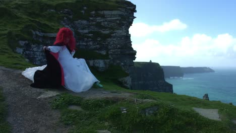 4k-Shot-of-a-Redhead-princess-on-Cliffs-of-Moher-View-in-Ireland