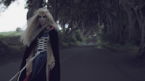 4k-Fantasy-Shot-in-Dark-Hedges,-Queen-Looking-at-Camera-(middle-shot)