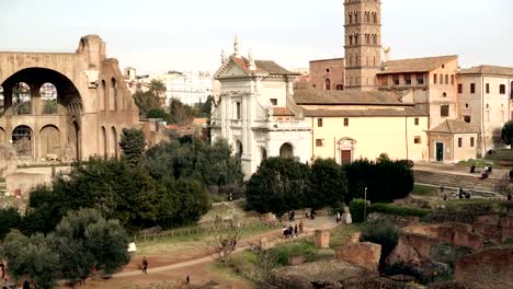 Panorama-of-the-Rome,-Italy-city-view-with-its-ruins,-columns,-palaces-and-an-impressive-Arch-of-Titus-and-Colosseum