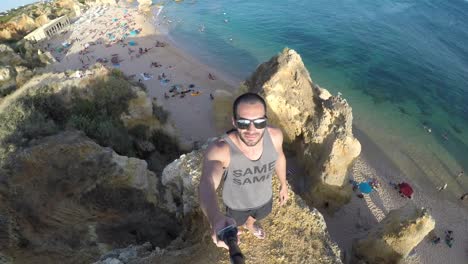 Guy-taking-a-selfie-in-a-beach-in-Algarve,-Portugal