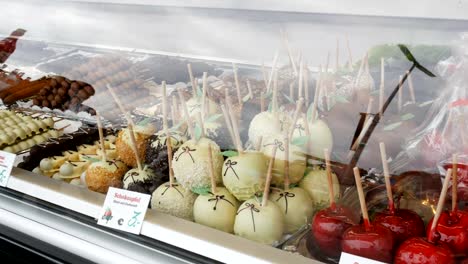 Various-fruit-apples,-bananas-in-the-glaze-on-the-showcase-during-the-world-famous-beer-festival-Oktoberfest,-in-Munich,-Bavaria