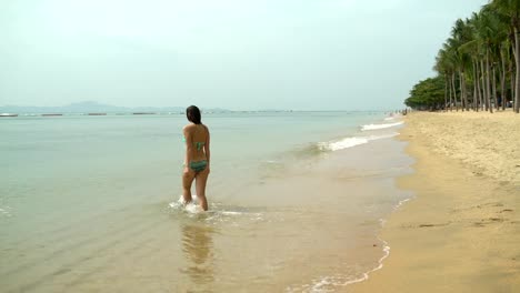 A-woman-goes-to-bathe-in-the-sea