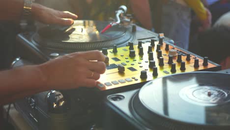 close-up-dj-hand-scratching-vinyl-record-on-turntable-on-a-party