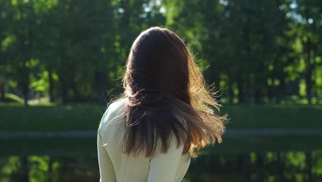 Woman-flip-auburn-shining-sunlit-hair,-slow-motion