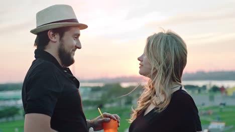 Young-European-couple-dancing-together-and-enjoying-sunset-at-summer-rooftop-party