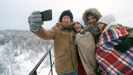 Joyful-Young-Tourists-Photographing-Outdoor-at-Winter-Day