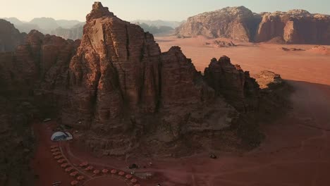 Aerial-view-of-camping-tents-and-dome-tents-along-the-rock-in-Wadi-Rum-desert,-Jordan