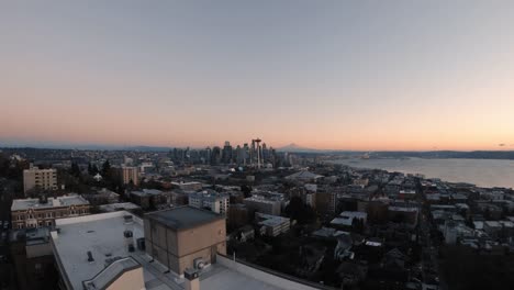 Building-Top-Aerial-Reveal-of-Seattle-Cityscape-and-Mt-Rainier