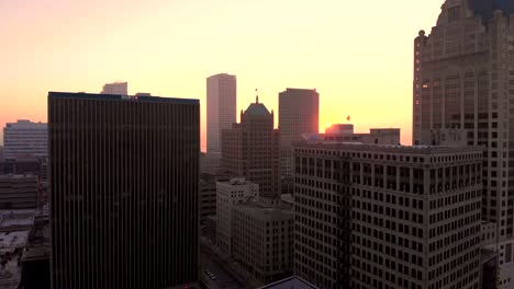 Aerial-view-of-skyscrapers-in-american-city-at-dawn.-Downtown-Milwaukee,-Wisconsin,-United-States.-Drone-shots,-sunrise,-sunlight,-from-above.