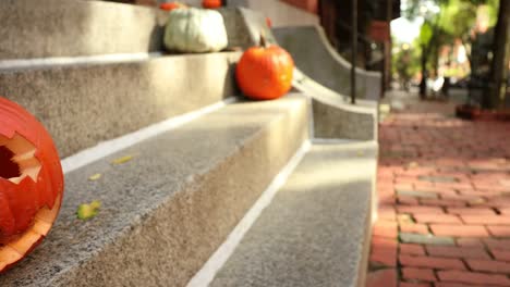 A-scary-carved-pumpkin-Jack-o-Lantern-on-the-steps-of-a-home-before-Halloween-trick-or-treat