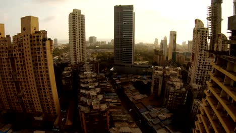 Bombey-skyscrapers-far-Arabian-sea-sun-shines-trough-clouds-in-sky-top-view