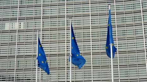 Amazing-view-of-three-European-Union-flags-with-yellow-star-circles-waving-at-the-EU-office-in-Brussels-on-a-sunny-day-in-spring.