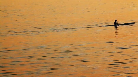 Man-paddling-a-kayak-in-the-sunset