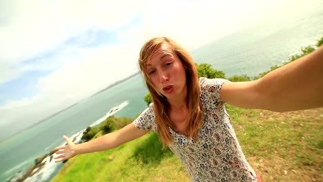 Self-portrait-of-young-woman-on-coastline-hill