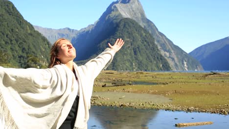 Serene-woman-relaxes-in-nature,-Milford-sound