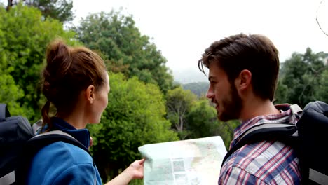 Rear-view-of-hikers-looking-a-map-with-a-compass