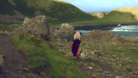 4k-Fantasy-Shot-on-Giant's-Causeway-of-a-Queen-Standing-in-the-Wind