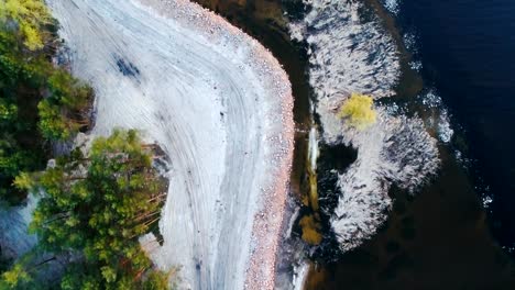 Aerial-footage.-Fly-over-coast-at-evening,-vertial-shot