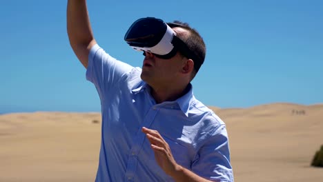 Video-of-man-exploring-virtual-reality-on-the-desert-in-4k