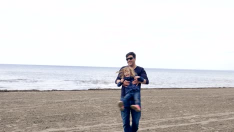 Father-Spinning-Daughter-on-a-Sandy-Shore-of-Lake-Ontario