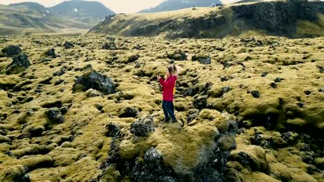 Aerial-view-of-two-happy-woman-standing-on-the-lava-field-in-Iceland-and-making-selfie-photo-on-smartphone