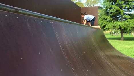 Young-girl-climbs-and-slides-on-a-metal-structure