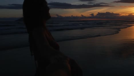 Girlfriend-holding-hands-Boyfriend-at-Sunset-Beach