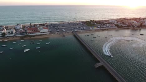 Two-jet-ski-riders-during-sunset---Praia-de-Faro,-Algarve,-Portugal