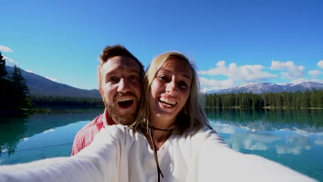 couple-takes-selfies-by-the-lake-on-a-sunny-day